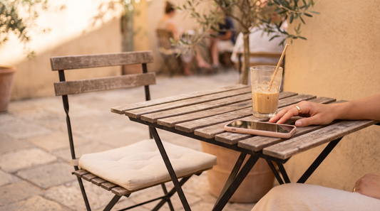 Cafe table with an empty chair and a phone lying face down, what a situationship feels like
