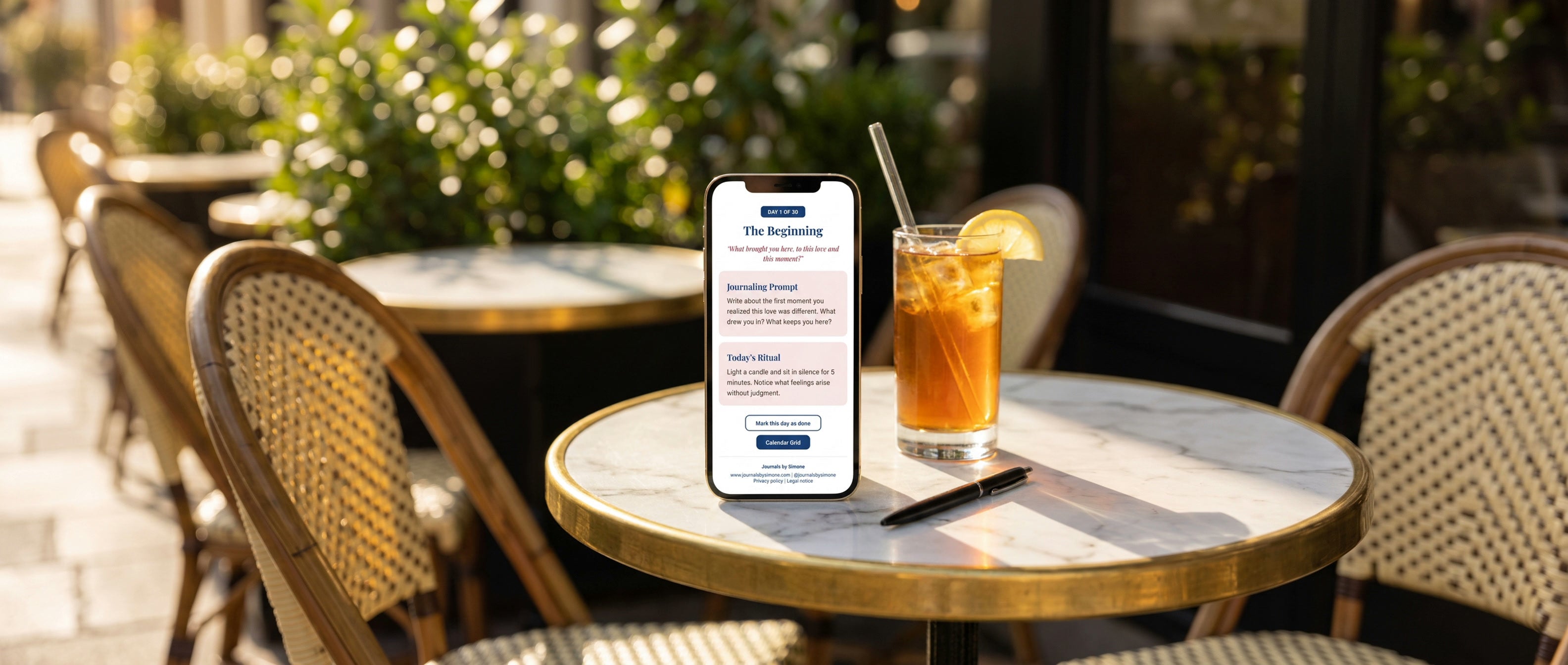 Day 1 of the Emotional Clarity Calendar shown on a phone at a Parisian summer cafe terrace with iced tea, widescreen hero