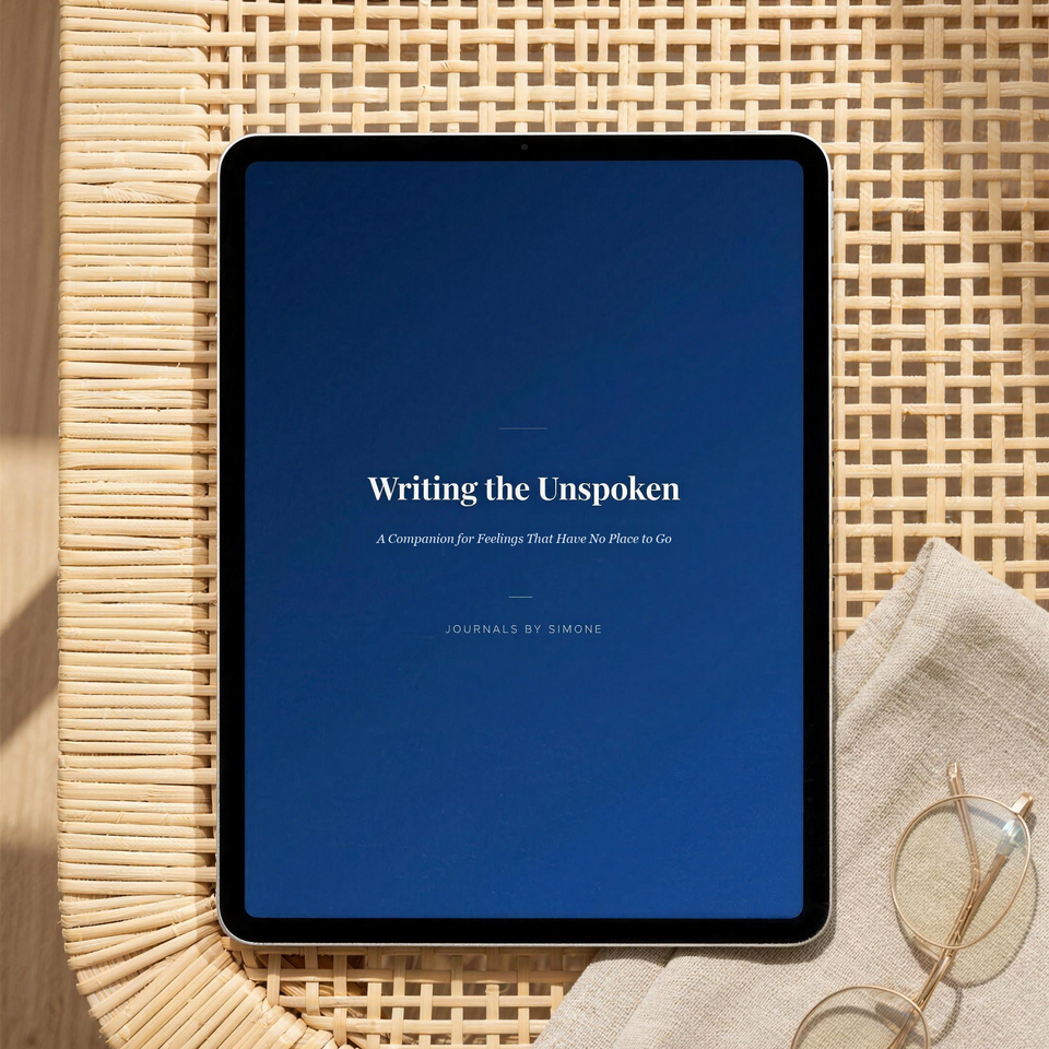 Writing the Unspoken guided eBook shown on a tablet on a rattan table