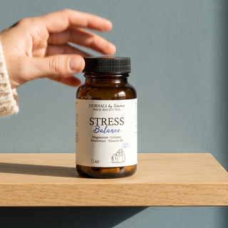 Braune Glasflasche Stress Balance auf einem Eichenregal, eine Hand greift danach